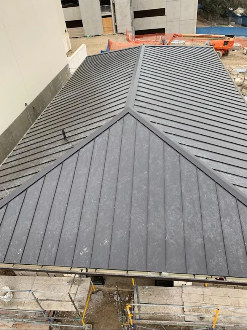 Commercial metal roof construction with crane equipment in Medina